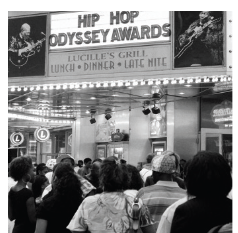 Archival scene beneath a Hip Hop Odyssey Awards marquee